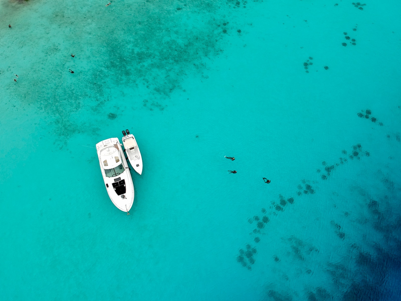 aerial view of white and black boat on sea during daytime